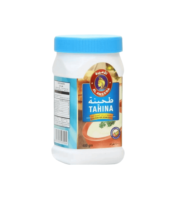 Jar of tahina with a blue lid on a white background