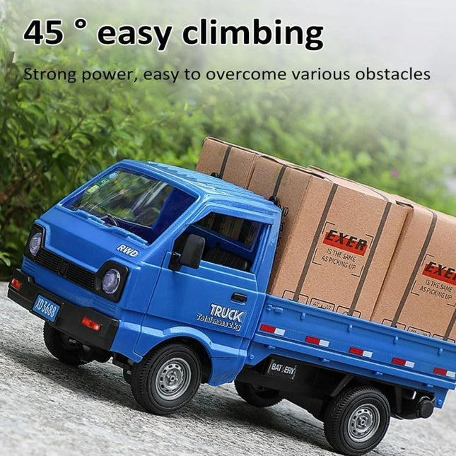 Blue toy truck with cardboard boxes on a gravel path with greenery in the background