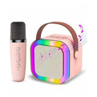 Pink microphone and colorful Bluetooth speaker on a white background