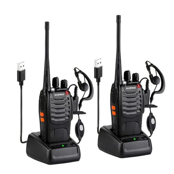 Two black walkie-talkies with earpieces on a white background