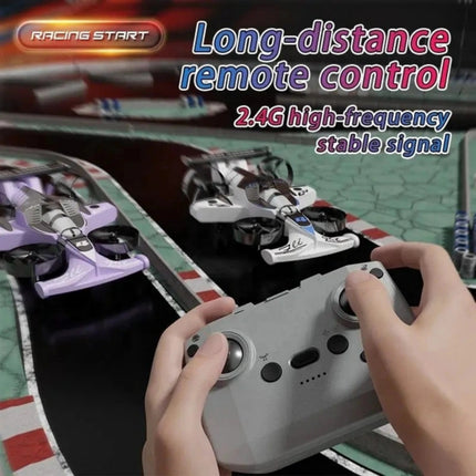 Person controlling model cars with a remote control on a racing track