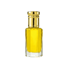 Yellow glass bottle with gold cap on a white background