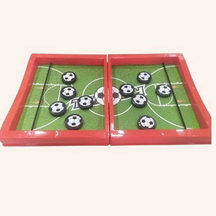 Tabletop game with soccer ball pieces on a green field layout