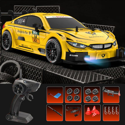 Yellow toy race car with remote control and additional parts on a black background