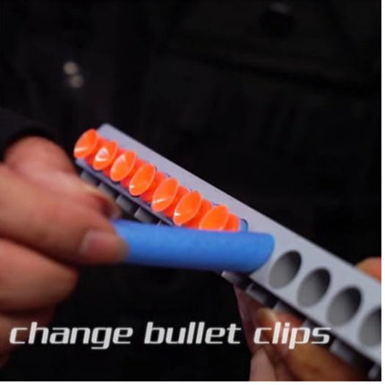 Person changing bullet clips using a tool with orange and gray components.