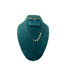 Teal necklace on a teal mannequin bust with a white background