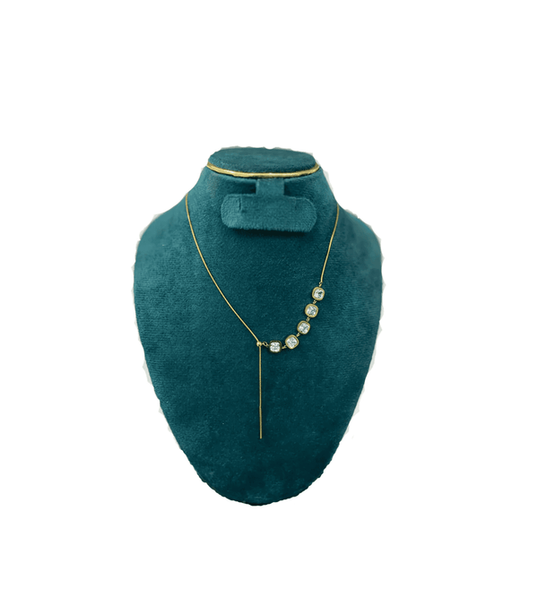 Teal necklace on a teal mannequin bust with a white background