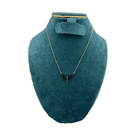 Jewelry set with necklace and earrings on a teal mannequin bust.