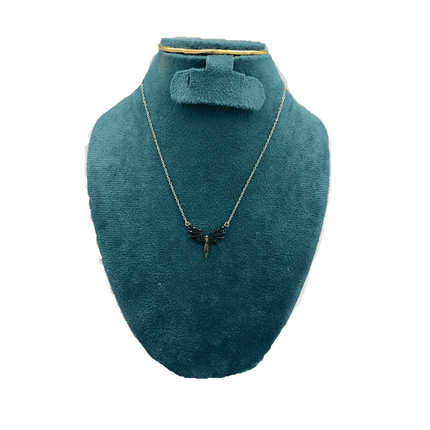 Jewelry set with necklace and earrings on a teal mannequin bust.