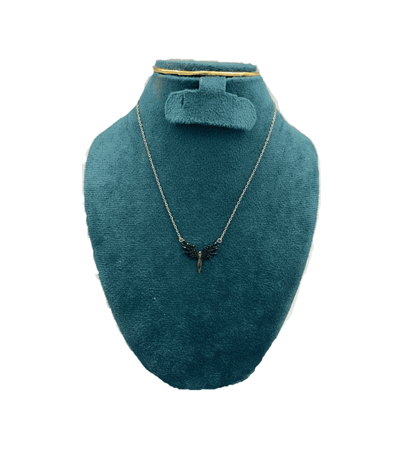 Jewelry set with necklace and earrings on a teal mannequin bust.