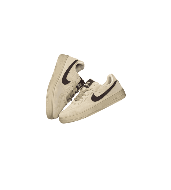 Pair of beige sneakers with black swoosh logo on a white background