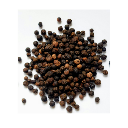 Pile of black peppercorns on a white background