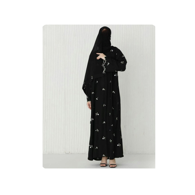 Person wearing a black abaya with floral embroidery on a white background