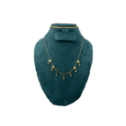 Necklace displayed on a green mannequin bust against a white background