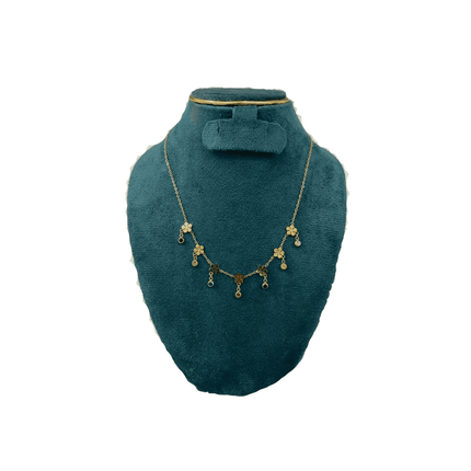 Necklace displayed on a green mannequin bust against a white background