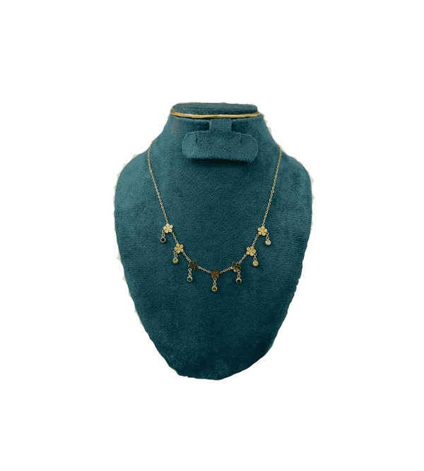 Necklace displayed on a green mannequin bust against a white background