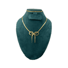 Gold necklace on a green mannequin bust with a white background