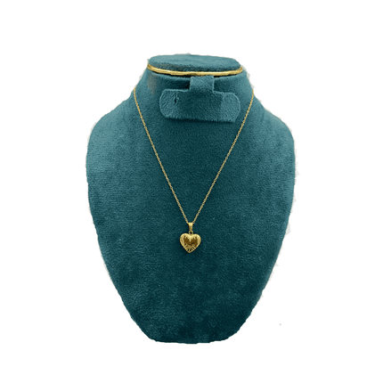 Gold heart-shaped necklace on a teal mannequin bust against a white background