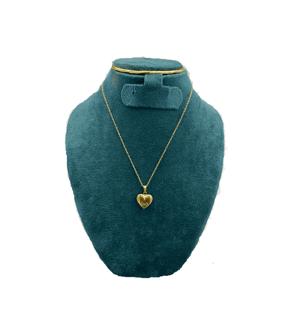 Gold heart-shaped necklace on a teal mannequin bust against a white background