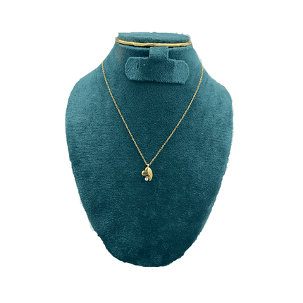 Gold necklace on a green mannequin bust with a white background