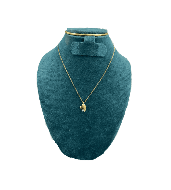 Gold necklace on a green mannequin bust with a white background