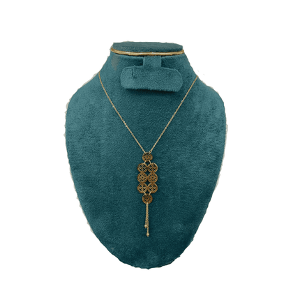 Teal velvet mannequin with a gold necklace and bow tie on a white background