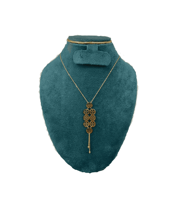 Teal velvet mannequin with a gold necklace and bow tie on a white background