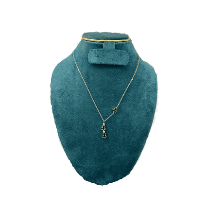 Teal jewelry display with necklace and earrings on a white background