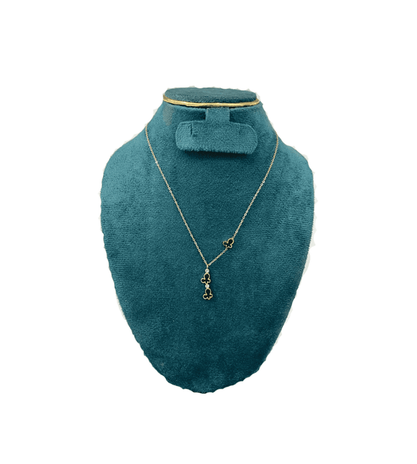 Teal jewelry display with necklace and earrings on a white background