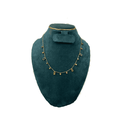 Necklace  on a green velvet bust against a white background