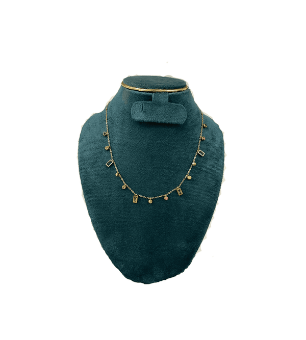 Necklace  on a green velvet bust against a white background