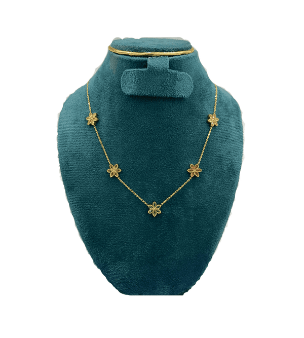 Necklace with colorful flower pendants on a green velvet stand