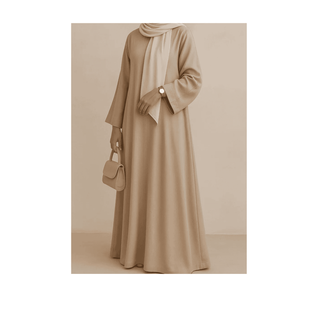 Person wearing a long beige dress with a matching hijab against a neutral background