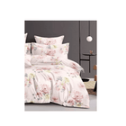 Floral bedding set with pillows on a bed in a bedroom setting.