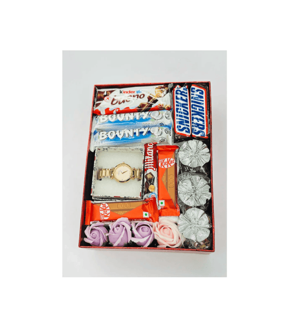 Gift set with snacks, a watch, and decorative items in a box on a white background