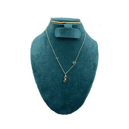 Gold necklace on a teal mannequin bust with a white background
