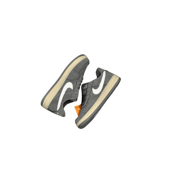 Gray sneakers with a white swoosh logo on a white background
