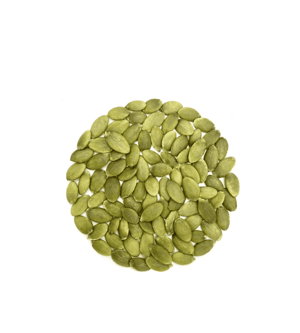 Pile of green pumpkin seeds on a white background