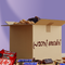 Open cardboard box with snacks and candy bars on a purple background