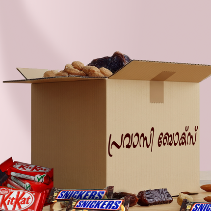 Open cardboard box with chocolate bars and dates on a light pink background