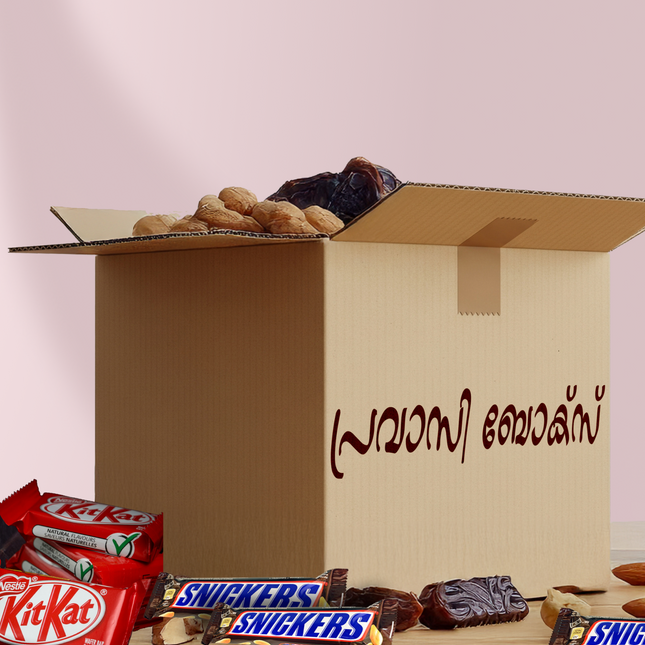 Open cardboard box with chocolate bars and dates on a light pink background