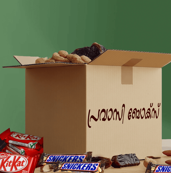 Open cardboard box with snacks and candy bars on a green background