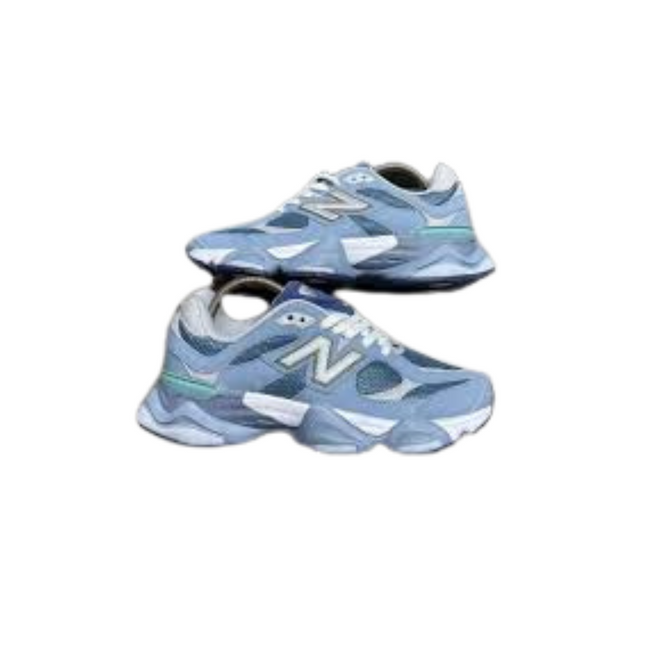 Pair of light blue sneakers with white soles on a white background