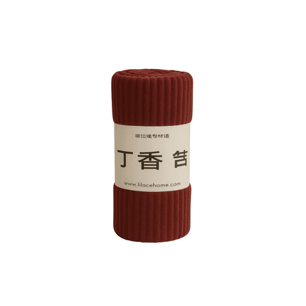 Maroon soft blanket with a label on a white background