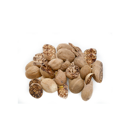 Pile of dried nutmeg on a white background