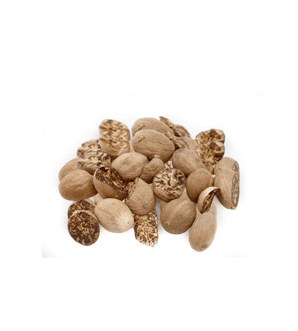 Pile of dried nutmeg on a white background