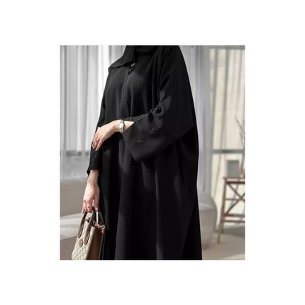 Person wearing a black outfit with a blurred background