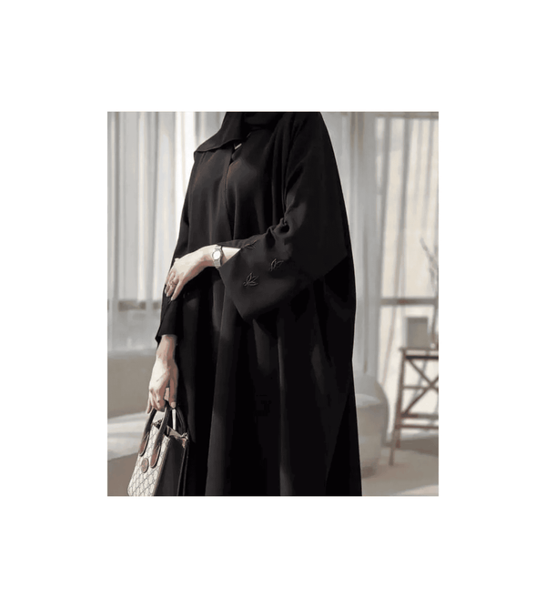 Person wearing a black outfit with a blurred background