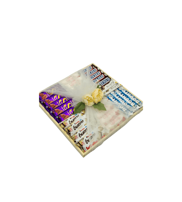 Gift box with Cadbury chocolate bars and a yellow flower on a white background