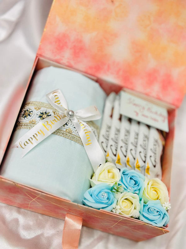 Gift set with a candle, soap flowers, and a card in a decorative box.